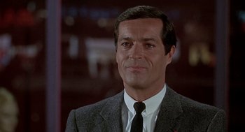 Movie still from “Topaz” (1969), directed by Alfred Hitchcock – A man in a suit and tie looking at the camera; Close Up shot, Low angle