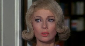 Movie still from “Topaz” (1969), directed by Alfred Hitchcock – A woman's face with blonde hair and blue eyes; Close Up shot, Over the shoulder angle