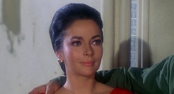 Movie still from “Topaz” (1969), directed by Alfred Hitchcock – A woman's face in a red dress; Close Up shot, Over the shoulder angle