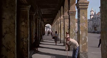 Movie still from “Topaz” (1969), directed by Alfred Hitchcock – A group of people walking down a sidewalk; Wide shot, High angle