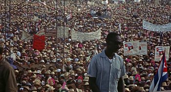 Movie still from “Topaz” (1969), directed by Alfred Hitchcock – A large group of people gathered in a large crowd; Wide shot, High angle