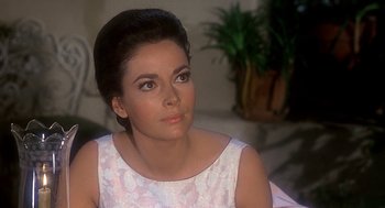 Movie still from “Topaz” (1969), directed by Alfred Hitchcock – A person sitting in a chair; Close Up shot, Over the shoulder angle