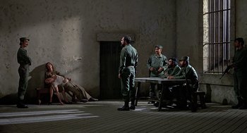 Movie still from “Topaz” (1969), directed by Alfred Hitchcock – A group of men sitting around a table in a room; Wide shot, High angle