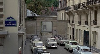 Movie still from “Topaz” (1969), directed by Alfred Hitchcock – A street filled with lots of parked cars next to tall buildings; Extreme Wide shot, High angle