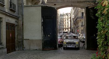 Movie still from “Topaz” (1969), directed by Alfred Hitchcock – Cars are parked on the side of the street; Extreme Wide shot, High angle