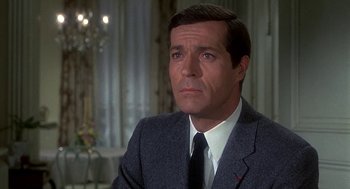 Movie still from “Topaz” (1969), directed by Alfred Hitchcock – A person wearing a suit and a tie; Close Up shot, High angle