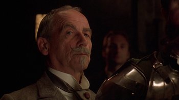 Movie still from “Topsy-Turvy” (1999), directed by Mike Leigh – An older man with a mustache and a beard; Close Up shot, Low angle