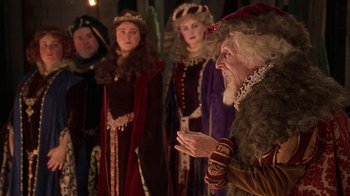Movie still from “Topsy-Turvy” (1999), directed by Mike Leigh – A group of people dressed in medieval costumes; Medium shot, Over the shoulder angle