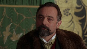 Movie still from “Topsy-Turvy” (1999), directed by Mike Leigh – A person with a beard and mustache; Close Up shot, Low angle