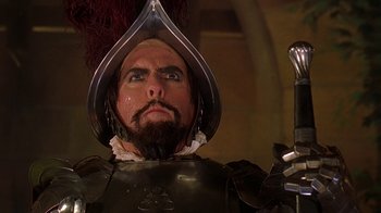 Movie still from “Topsy-Turvy” (1999), directed by Mike Leigh – A person wearing a suit of armor; Close Up shot, Low angle
