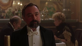Movie still from “Topsy-Turvy” (1999), directed by Mike Leigh – A man in a tuxedo with a long beard; Close Up shot, Low angle