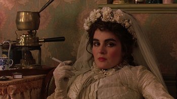 Movie still from “Topsy-Turvy” (1999), directed by Mike Leigh – A woman in a wedding dress smoking a cigarette; Close Up shot, Over the shoulder angle