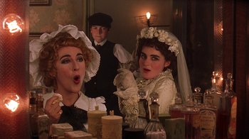Movie still from “Topsy-Turvy” (1999), directed by Mike Leigh – A group of people dressed up as victorian women; Close Up shot, Over the shoulder angle