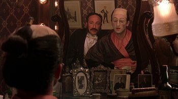 Movie still from “Topsy-Turvy” (1999), directed by Mike Leigh – A man and a woman sitting in front of a mirror; Medium shot, Over the shoulder angle