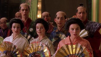 Movie still from “Topsy-Turvy” (1999), directed by Mike Leigh – A group of people in traditional japanese clothing; Medium shot, Over the shoulder angle