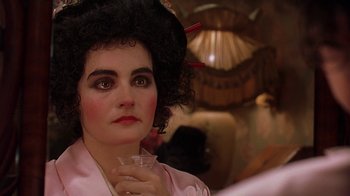 Movie still from “Topsy-Turvy” (1999), directed by Mike Leigh – A woman in a pink robe holding a glass of wine; Close Up shot, Over the shoulder angle