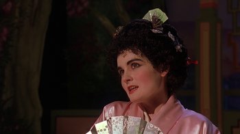 Movie still from “Topsy-Turvy” (1999), directed by Mike Leigh – A woman in a pink kimono holding a fan in her hand; Close Up shot, Over the shoulder angle