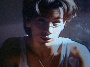 Movie still from “Totally F***ed Up” (1993), directed by Gregg Araki – A man's face with a cigarette in his mouth; Extreme Close Up shot, High angle