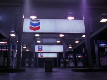 A gas station that is lit up at night