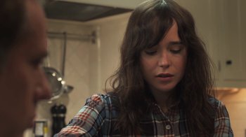 Movie still from “Touchy Feely” (2013), directed by Lynn Shelton – A woman in a plaid shirt is looking down at her face; Close Up shot, High angle