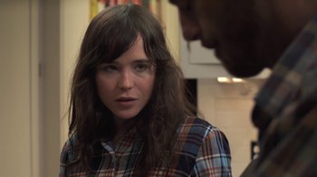 Movie still from “Touchy Feely” (2013), directed by Lynn Shelton – A woman in a plaid shirt is looking at a man; Close Up shot, Over the shoulder angle