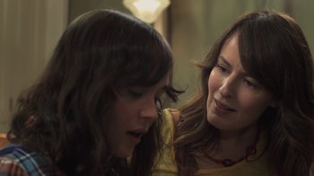 Movie still from “Touchy Feely” (2013), directed by Lynn Shelton – Two women looking at each other in a dimly - lit room; Close Up shot, Over the shoulder angle