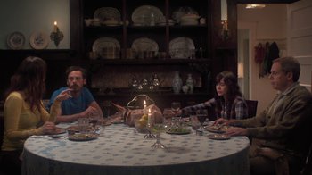 Movie still from “Touchy Feely” (2013), directed by Lynn Shelton – A man and a woman sitting at a dinner table; Wide shot, High angle
