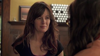 Movie still from “Touchy Feely” (2013), directed by Lynn Shelton – A person sitting in a chair; Close Up shot, Over the shoulder angle