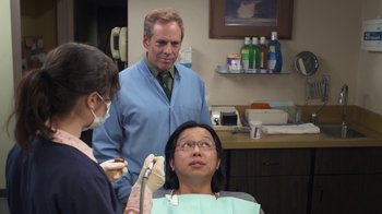 Movie still from “Touchy Feely” (2013), directed by Lynn Shelton – A man and a woman getting their teeth checked by a dentist; Medium shot, Over the shoulder angle