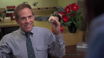 Movie still from “Touchy Feely” (2013), directed by Lynn Shelton – A man sitting at a table holding a piece of food; Close Up shot, Over the shoulder angle