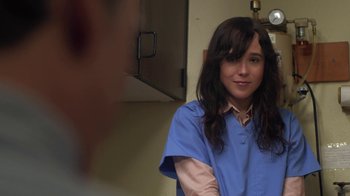 Movie still from “Touchy Feely” (2013), directed by Lynn Shelton – A woman in a blue shirt is standing in front of a mirror; Close Up shot, Over the shoulder angle