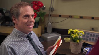 Movie still from “Touchy Feely” (2013), directed by Lynn Shelton – A man sitting at a table holding a card; Close Up shot, Over the shoulder angle