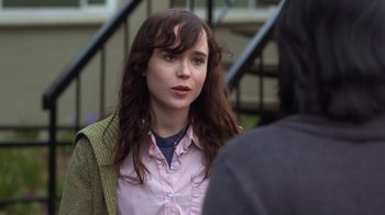 Movie still from “Touchy Feely” (2013), directed by Lynn Shelton – A woman in a pink shirt and a green sweater; Close Up shot, Over the shoulder angle
