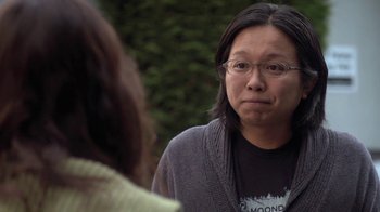 Movie still from “Touchy Feely” (2013), directed by Lynn Shelton – A woman with glasses is looking at another woman; Close Up shot, Over the shoulder angle