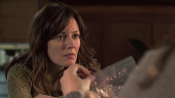 Movie still from “Touchy Feely” (2013), directed by Lynn Shelton – A person holding something in their hand; Close Up shot, Over the shoulder angle