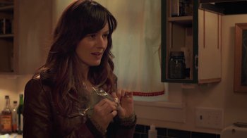 Movie still from “Touchy Feely” (2013), directed by Lynn Shelton – A woman holding a measuring tape in a kitchen; Close Up shot, Over the shoulder angle