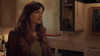 Movie still from “Touchy Feely” (2013), directed by Lynn Shelton – A woman with long brown hair wearing a leather jacket; Close Up shot, Over the shoulder angle