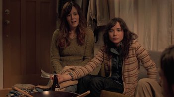 Movie still from “Touchy Feely” (2013), directed by Lynn Shelton – Two women sitting next to each other in a room; Medium shot, Over the shoulder angle