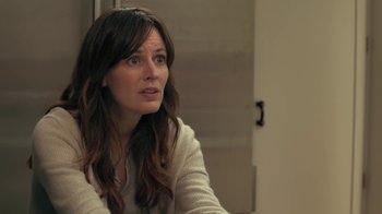 Movie still from “Touchy Feely” (2013), directed by Lynn Shelton – A woman sitting at a table looking at the camera; Close Up shot, Over the shoulder angle