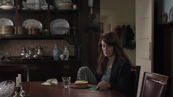 Movie still from “Touchy Feely” (2013), directed by Lynn Shelton – A woman sitting at a table with a stack of pancakes; Medium shot, High angle