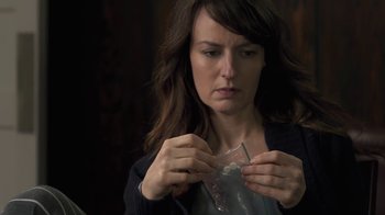 Movie still from “Touchy Feely” (2013), directed by Lynn Shelton – A woman holding a piece of paper in her hands; Close Up shot, Over the shoulder angle