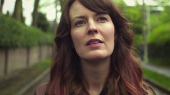 Movie still from “Touchy Feely” (2013), directed by Lynn Shelton – A person with long brown hair; Close Up shot, Low angle