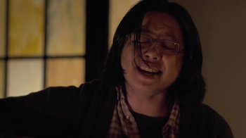 Movie still from “Touchy Feely” (2013), directed by Lynn Shelton – A man with long hair and glasses is crying; Close Up shot, Low angle