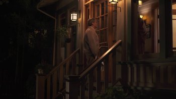 Movie still from “Touchy Feely” (2013), directed by Lynn Shelton – A man standing on the steps of a house; Wide shot, Low angle