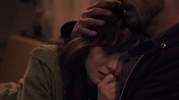 Movie still from “Touchy Feely” (2013), directed by Lynn Shelton – A woman with her hand on her head; Close Up shot, Over the shoulder angle