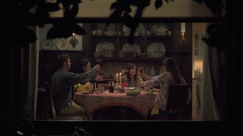Movie still from “Touchy Feely” (2013), directed by Lynn Shelton – A group of people sitting around a table drinking wine; Wide shot, High angle