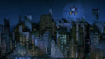 Movie still from “Toys” (1992), directed by Barry Levinson – A city skyline at night with buildings lit up in the dark; Extreme Wide shot, High angle