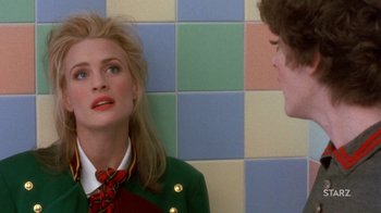 Movie still from “Toys” (1992), directed by Barry Levinson – A woman in a red tie and a man in a green jacket; Close Up shot, Over the shoulder angle