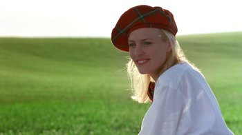 Movie still from “Toys” (1992), directed by Barry Levinson – A woman wearing a red plaid hat and a white shirt; Close Up shot, Low angle