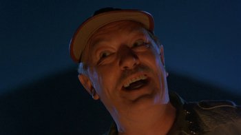 Movie still from “Toys” (1992), directed by Barry Levinson – A person wearing a hat; Close Up shot, Low angle